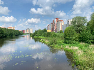 Fototapeta na wymiar Moscow region, the city of Balashikha. Pekhorka river in summer morning and view of Zarechnaya street