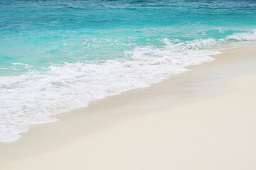 Fototapeta na wymiar Soft white waves crashing tropical sandy beach, copy space