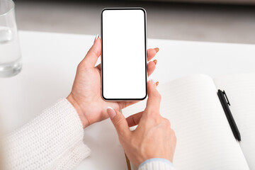 New message and news. Female hands are checking smartphone