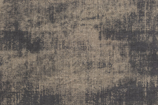 Rustic background with canvas texture with with spots of gray paint