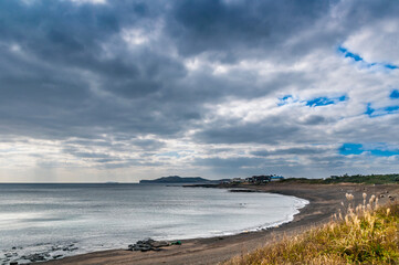 Dramatic cloudy sky. Worth a stop. Breathtaking view of Yongmoeri Hean, Jeju Island from higher...