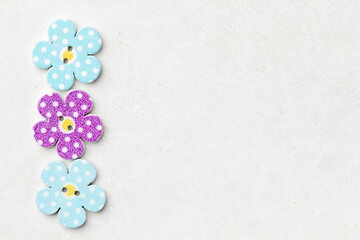 Fototapeta na wymiar Creative background with decorative wooden buttons shaped like flowers