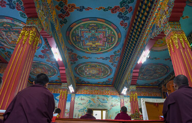 Monks on prayer at the tibetan buddhist monastery of Jangchub Choeling near Pokhara on Nepal
