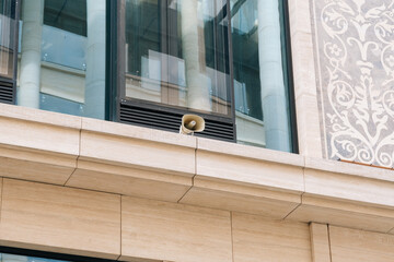 loudspeaker on the wall of the office building. Business Center alerts city dwellers and businessmen using loudspeakers