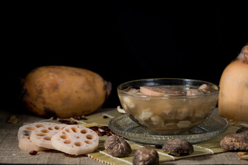 Lotus root soup with beans in a bowl and Chinese herbs, shiitake mushroom, lotus root