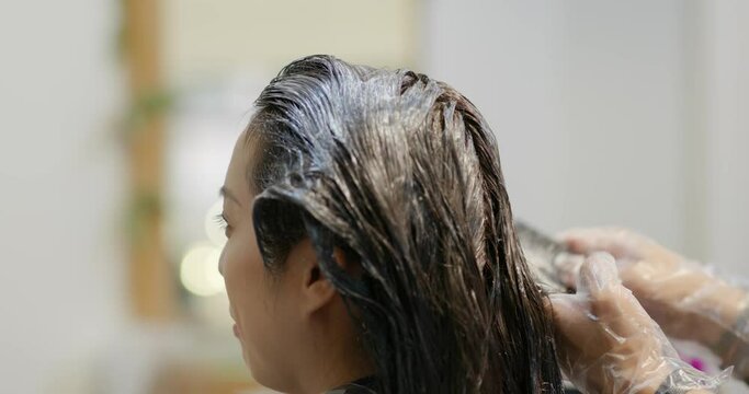 Woman with hair dye at beauty salon