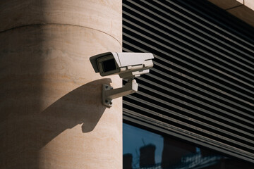 A CCTV camera installed at the business center. Residential house protects the territory