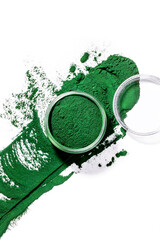 Organic green spirulina chlorella algae powder splash on white background