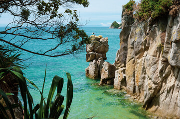 View from a cliff of rock formations in Abel Tasman in New Zealand on a sunny day