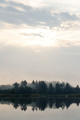 Obraz na płótnie Canvas Sunrise over a peaceful lake