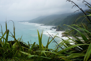 View of the coastline on a cloudy day with nature on the front. New Zealand West Coast, South Island.