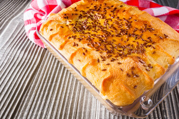 freshly baked cabbage pie on rustic wooden background