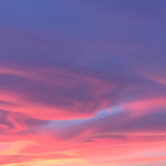Pink lenticularis clouds formations at sunset 