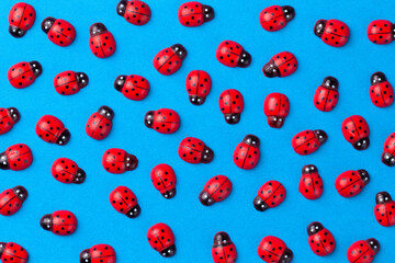 Bright creative colored background with decorative wooden ladybugs