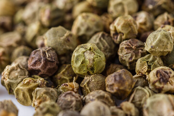 spicy green peppers on white acrylic background
