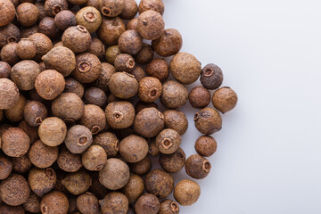 fresh spicy peppers allspice on white acrylic background