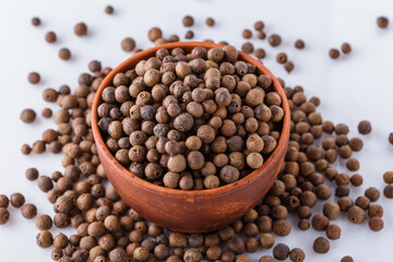 fresh spicy peppers allspice on white acrylic background