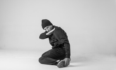 Black and white stylish modern epic portrait of bboy on a white background. Breakdance and hiphop dancer. Mysterious and cool.