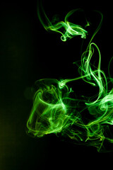 Green smoke motion on black background.