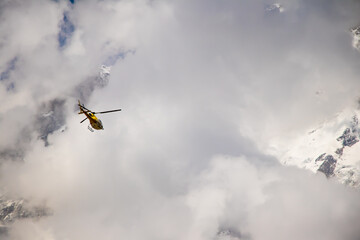 Image of a helicopter flying in a mountain area of kedarnath uttarakhand