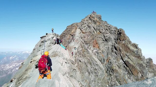Alpinists climbing on rocks to Grossglockner the highest mountain in Austria and East Alps