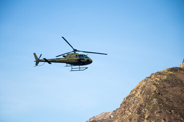 Fototapeta na wymiar Image of a helicopter flying in a mountain area of kedarnath uttarakhand