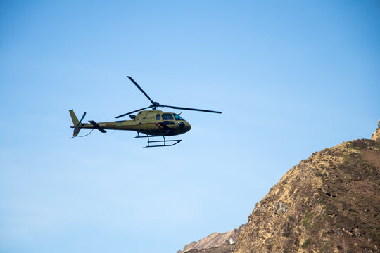 Image of a helicopter flying in a mountain area of kedarnath uttarakhand