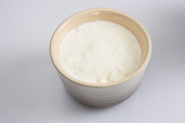 close up isolated top view shot of a brown beige bowl filled with a delicious blue cheese dipping...