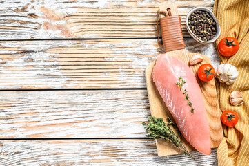 Raw Turkey steaks. Breast fillet with herbs. White wooden background. Top view. Copy space