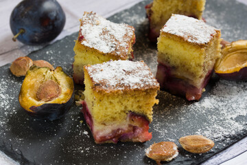 Homemade plum cake and a plum.