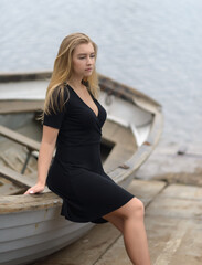 Young woman sitting down on the boat.