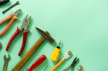 Flat lay of repair tools on a mint background. Space for text