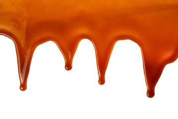 Background of flowing caramel sauce isolated on white.
