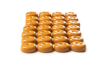 Tasty caramel candy isolated on white background.