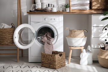 Stylish bathroom interior with modern washing machine