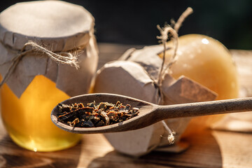 Wooden spoon of propolis granules.Bee glue.Apitherapy
