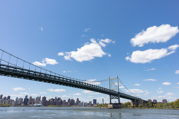 The Triborough Bridge connecting Astoria Queens New York to Wards and Randall's Island over the East River with the Manhattan Skyline