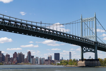 The Triborough Bridge connecting Astoria Queens New York to Wards and Randall's Island over the East River with the Manhattan Skyline