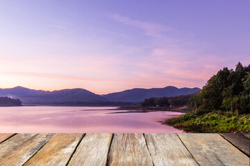 Wood table top on blurred beautiful sunrise at the lake and mountain. Beauty natural background - can be used for product display montage