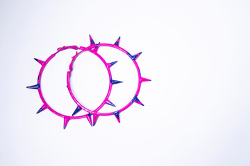 Pink and blue earrings with spikes. jewelry and accessories concept. Isolated, copy space. Macro Shot. High quality photo