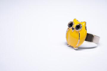 Golden ring with an yellow owl on it. jewelry and accessories concept. Isolated, copy space. Macro...