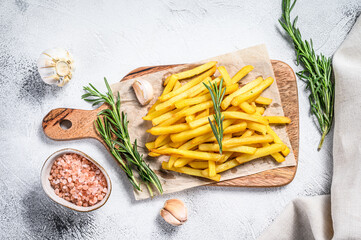 French fries on a cutting board, fried potatoes. White background. Top view