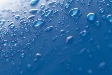 Rain droplets on a blue waterproof fabric  background