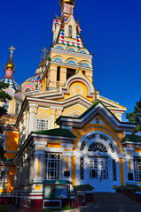 Fototapeta na wymiar Brightly painted Ascension Cathedral in Almaty's Panifilov Park on a sunny summer's morning.