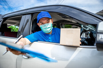 Asian deliveryman staff are preparing packages to deliver to customers who order online during the coronavirus or covid-19 outbreak.