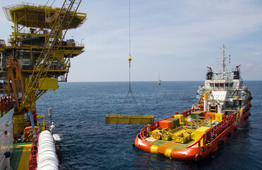 Cargo being loaded from a offshore platform onto a supply vessel