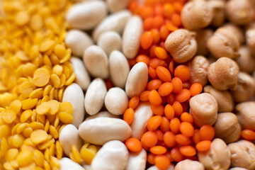 Macro detail of some legumes. Red lentil, dry chickpeas, beans and yellow lentils.