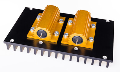 Two yellow power resistors bolted on black anodized aluminum heat sink on white background....