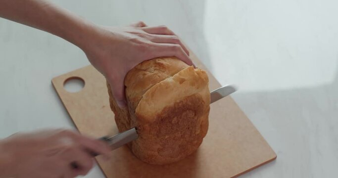 Cut a white bread with knife