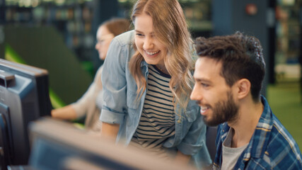 University Library: Bright Caucasian Girl and Talented Boy Study for Exams, Work on Assignment, Use Computer, Point at Screen,Talk, Look for Solution, Explain Subject. College Students Work Together